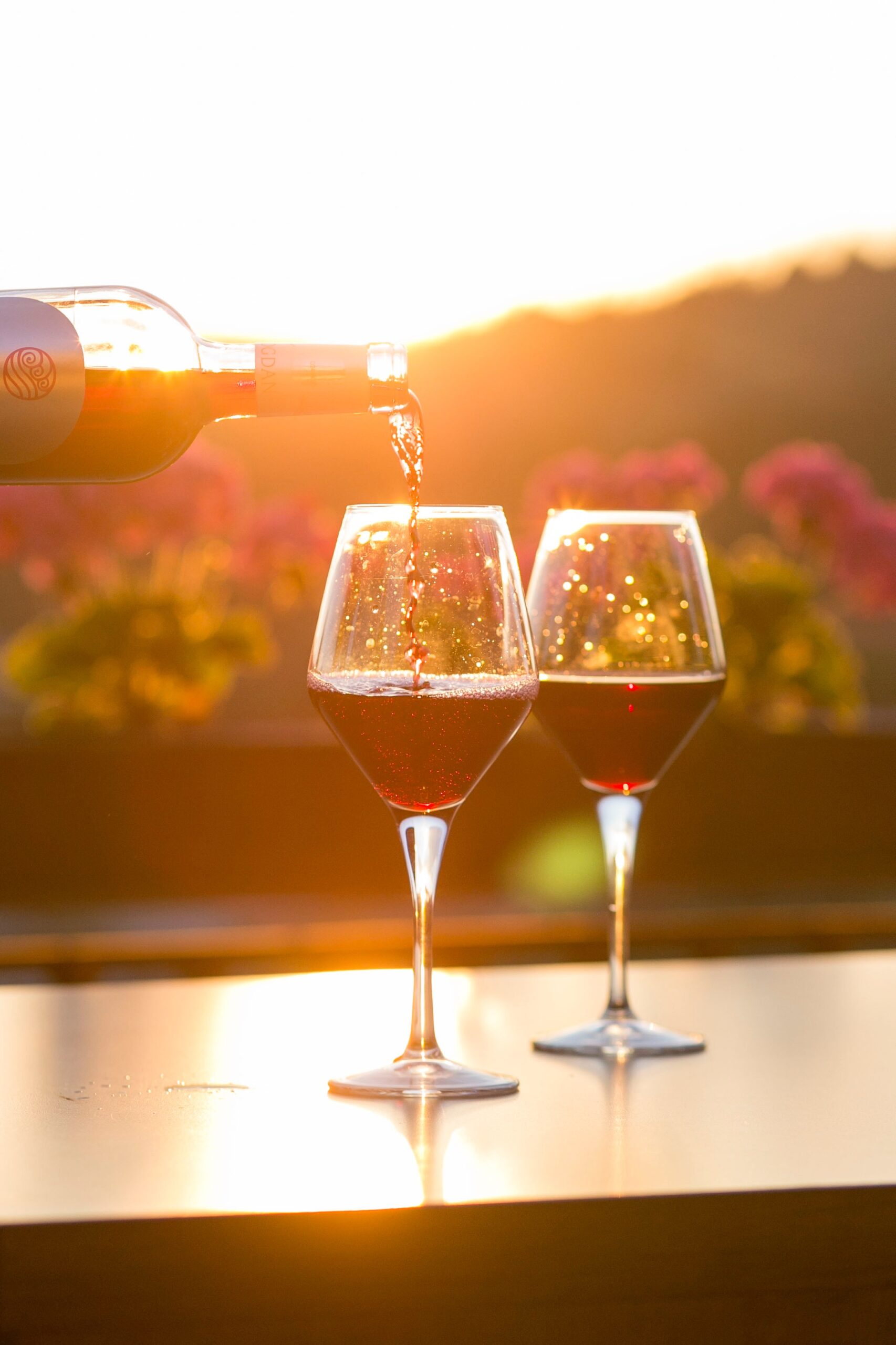 Pouring a glass of wine as the sun sets