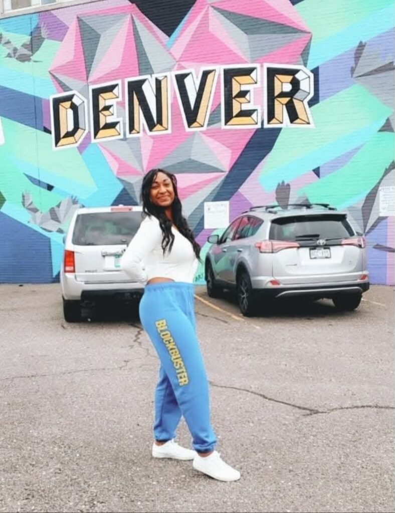 Standing in front of the Denver wall mural in Colorado
