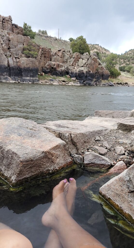 A woman sitting in a hot spring in Colorado