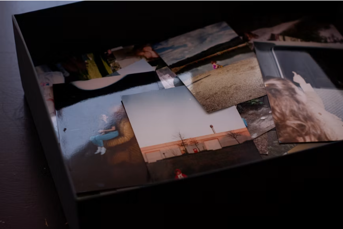 A shadow box filled with pictures of people and landscapes