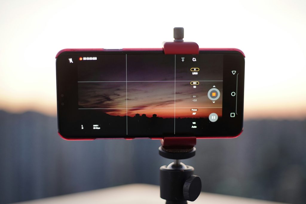 A phone set to record a sunset