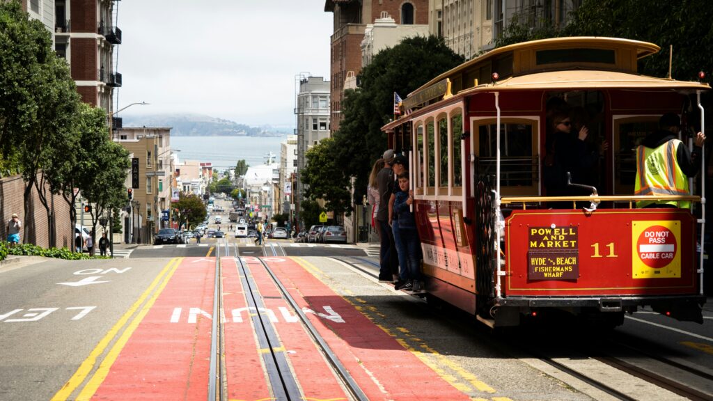 People taking a cable car on the streets of San Francisco