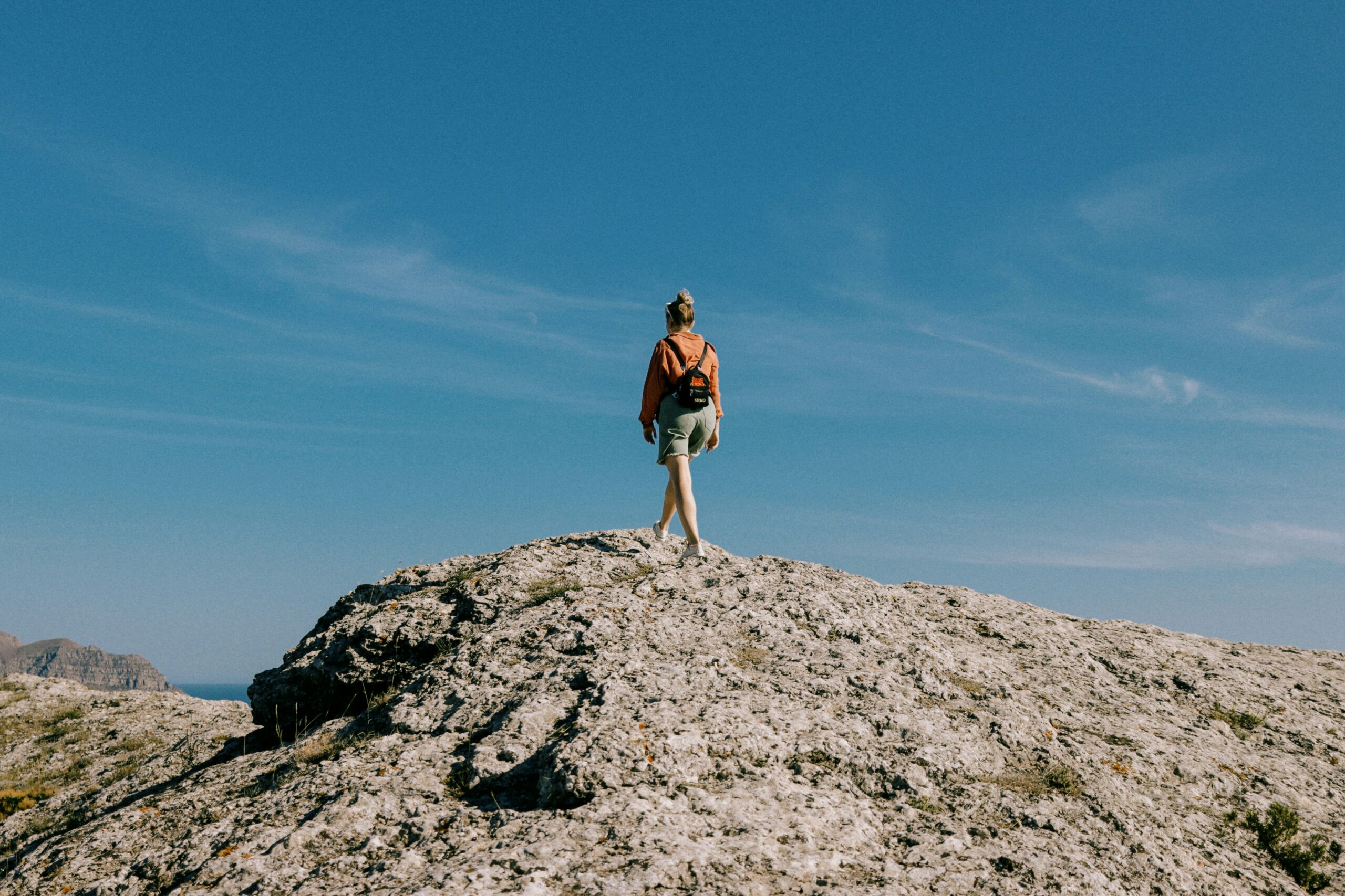 Woman standing on a rock looking a the horizon