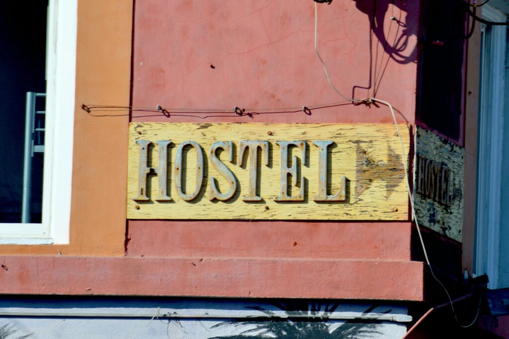 A hostel sign on the side of a building